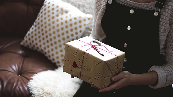 a kid holding a wrapped gift