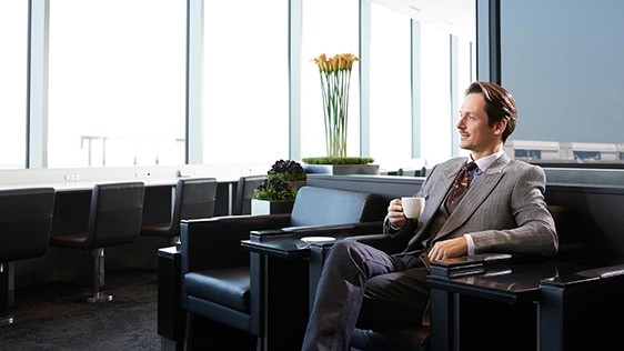 a man holding a cup at a lounge